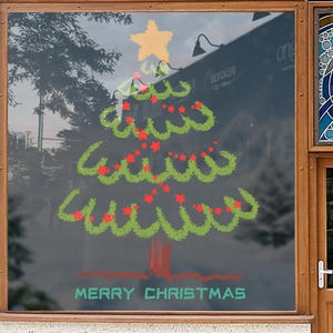 Green hand-drawn Christmas tree window decal with Merry Christmas text on glass