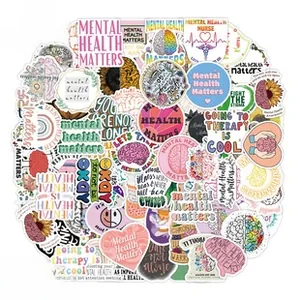 Flat lay of 105 mental health stickers with brain and floral patterns on white background