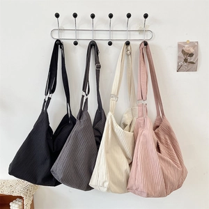 Detail view of large canvas hobo bags in four colors with adjustable wide straps