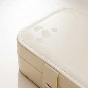 Waterproof PU leather jewelry storage box with cream textured finish and secure snap button