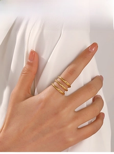 Close-up of model wearing stacked 18K gold plated stainless steel rings in minimalist style