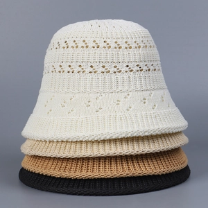Detail of four colors of breathable hollow knit bucket hats in stacked arrangement