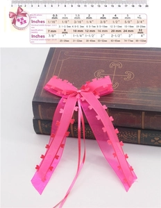 Pink chiffon bow with heart-shaped laser-cut edges and size comparison chart