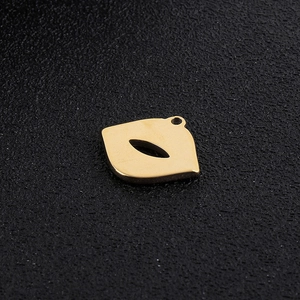 Close-up of golden lip-shaped hollow metal pendant for DIY jewelry making