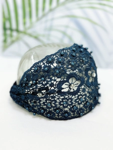 Detail of dark blue lace headband featuring delicate pearls and sparkling rhinestones
