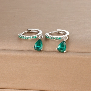 Detailed macro view of S925 silver earring with emerald green pear-cut drop stones