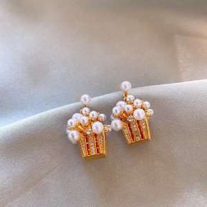Detailed close-up of 18K gold-plated popcorn earrings with pearls and zircon stones