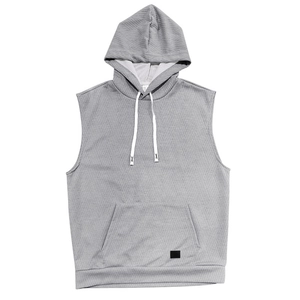 Gros plan sur le gilet à capuche gris sans manches montrant le tricot à losanges gaufré