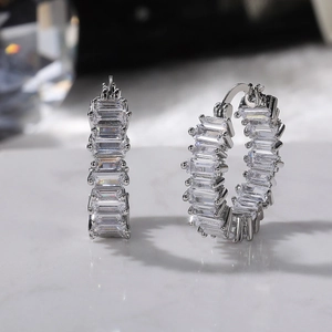 Macro shot of baguette-cut cubic zirconia stones set in silver hoop earrings