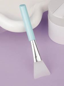 Close-up of flexible silicone brush head and silver ferrule for easy mud mask application