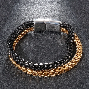 Detail view of double-layer wheat chain bracelet in black and gold stainless steel
