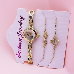 Close-up of golden fashion watch set with butterfly dial, rhinestones and matching bracelets