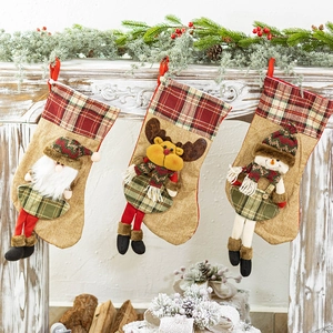 Three large knitted Christmas stockings with Santa, reindeer and snowman designs