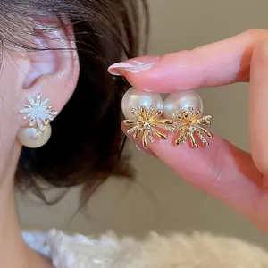 Elegant gold plated firework stud earrings with large white pearl and sparkling zircons