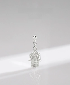 Detailed close-up of 925 sterling silver Hamsa pendant with intricate filigree engraving