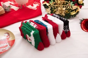 Close-up of thick coral fleece Christmas socks with festive Nordic snowflake patterns