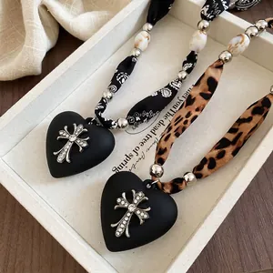 Leopard print and paisley fabric necklace with heart pendant and rhinestone cross charm