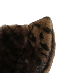 Macro shot of fluffy leopard print faux fur texture with soft gradient brown plush details