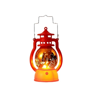 Red Christmas lantern with golden LED sphere featuring reindeer and tree patterns