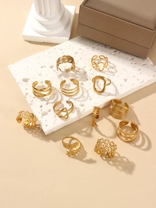 Set of 11 assorted 18k gold plated leaf and geometric rings on elegant display