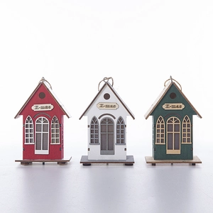 Three wooden Christmas house ornaments with X-mas labels in red, white and green