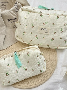 Quilted floral cosmetic bag set with blue begonia patterns for travel storage
