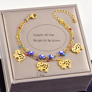 Detail view of double-layer gold evil eye bracelet with elephant charms on display box