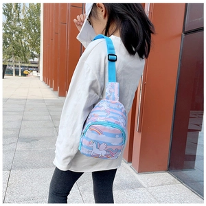 Outdoor shot of a child wearing a colorful unicorn crossbody bag with blue stripes