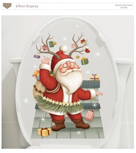 Close-up of a cartoon Santa Claus sticker applied on a white bathroom toilet lid