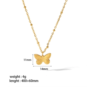 Macro detail of gold butterfly pendant with textured surface and size specifications
