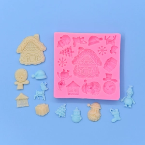 Pink Christmas silicone mold for DIY baking with snowman, deer and house shaped cavities