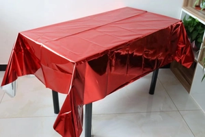 Detail of red metallic glossy table cover showing smooth reflective material and texture