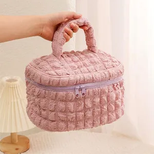 Pink quilted waffle makeup bag with sturdy handle and dual zipper for daily storage