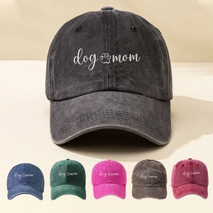 Detailed close-up of Dog Mom embroidery on vintage washed cotton baseball cap texture