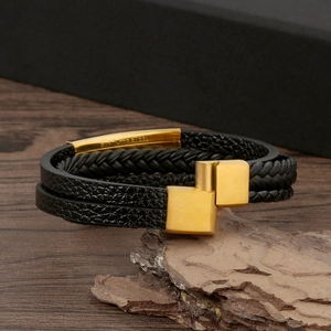 Macro shot of black braided leather bracelet with gold stainless steel magnetic clasp