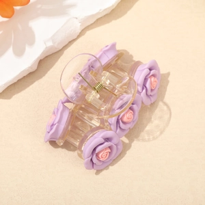 Detail view of transparent hair claw clip with 3D purple roses and pink flower centers
