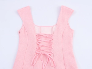 Detail of pink tweed dress featuring lace-up back design and side invisible zipper