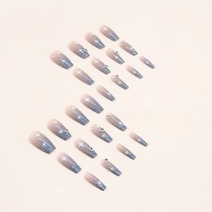 Blue gradient press-on nails with glitter, star patterns, and small rhinestones