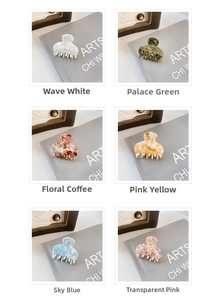 Detail view of six acetate mini hair claws in marble and floral patterns on a desk