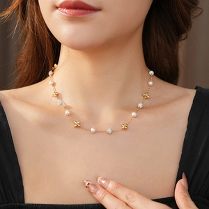 Detail of flower zircon and pearl necklace on model neck with gold plating finish