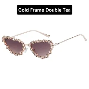 Detail view of heart-shaped gold frame sunglasses with sparkling rhinestones and tea lenses