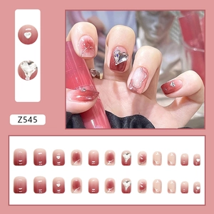 Elegant wine red gradient press-on nails featuring sparkling heart charms and glitter