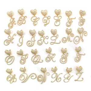 Detail view of 26 alphabet heart pendants featuring gold plating and sparkling rhinestones