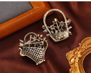 Detailed back view of vintage flower basket brooch showing secure safety pin clasp