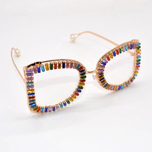 Oversized rose gold sunglasses with colorful crystals and pearl detail on a white background