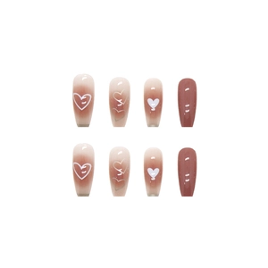 Nude to reddish-brown gradient press-on nails with white heart patterns and glossy finish