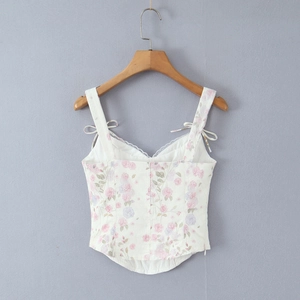 Close-up of French floral lace corset top with purple print on a wooden hanger