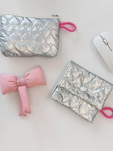 Silver quilted heart pattern pouch and clutch set with pink bow details on white background