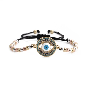 Adjustable woven evil eye bracelet with cubic zirconia and tri-color metal beads