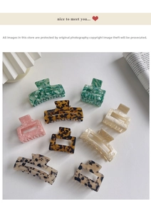 Detailed overhead view of multiple tortoiseshell and marble acetate hair claws on a white base